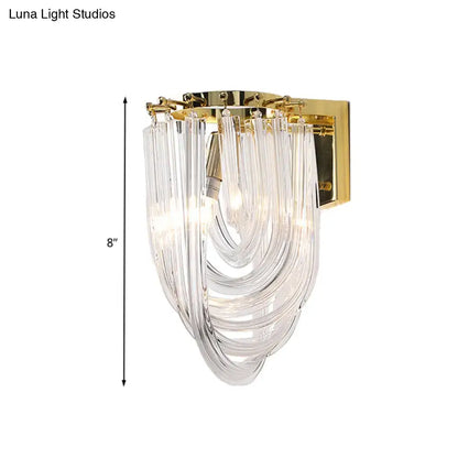 Modern gold and clear glass geometric wall sconce with gold metal frame for living room lighting featuring clear glass design