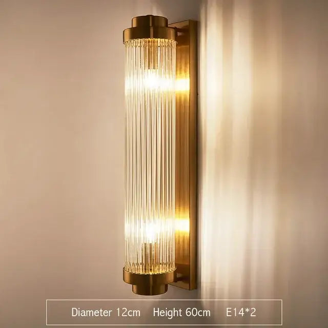 Brass-finished modern gold led wall lamp with vertical clear glass rods emitting warm light for bedroom use