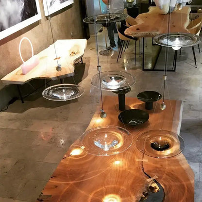 Modern gold and clear glass pendant lights with metallic fixtures hanging above a rustic wooden table decorbites clear glass pendant