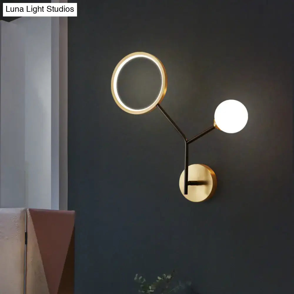 Modern gold and cream glass wall sconce lamp with circular mirror and spherical light fixture for bedroom lighting