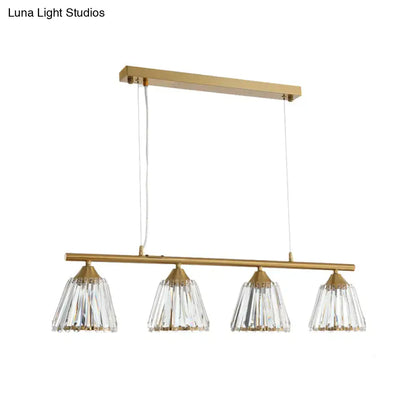 Modern gold and crystal pendant light with four clear faceted shades on a horizontal bar for 220v-240v use