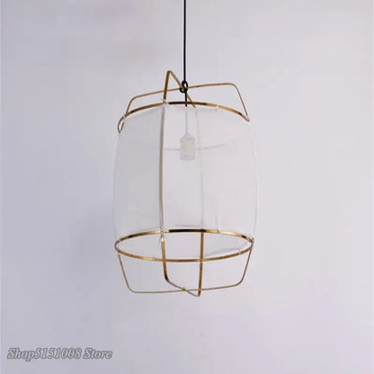 A modern gold and glass pendant light fixture with slender metal bars ideal for dining room decorbites bamboo linen