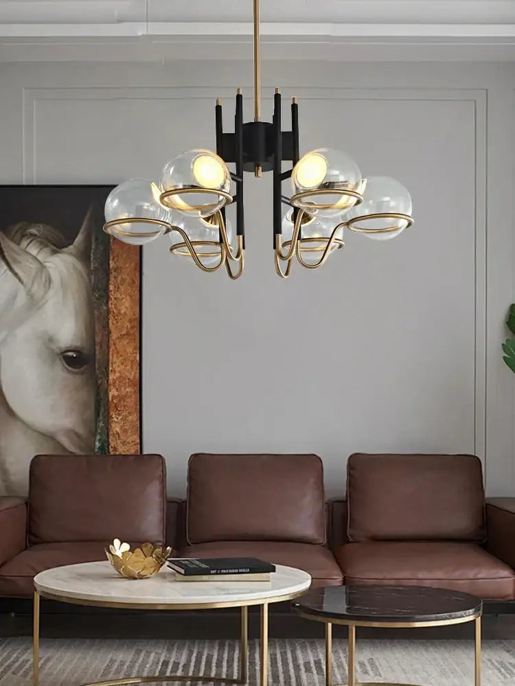 Modern gold and gray glass ceiling chandelier with black frame and gold metal arms holding clear gray glass globes for decorbites gray glass ceiling decor