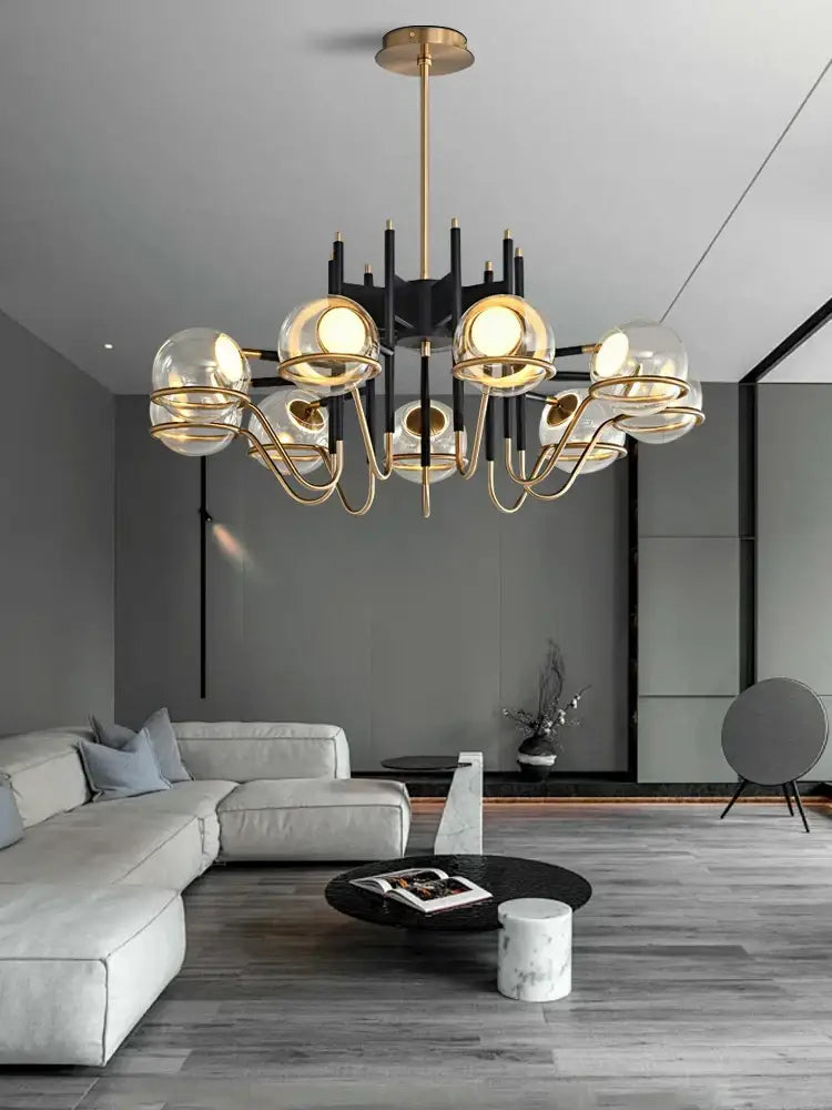 Modern gold and gray glass ceiling chandelier with multiple spherical glass shades and black structural arms for decorbites gray glass decor