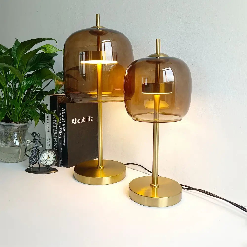 Two amber glass table lamps with brass bases in modern design ideal for bedroom decorbites glass table lamp use