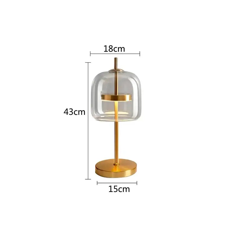 Modern gold and gray glass table lamp with clear glass dome and gold-toned metal base for bedroom use