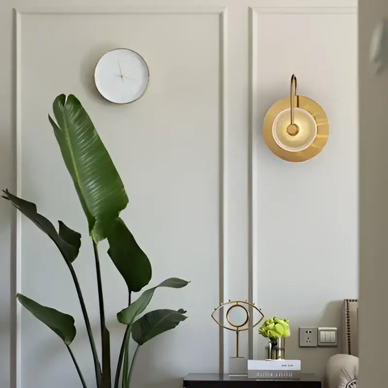 Modern gold wall sconce with green glass and warm light designed for bedroom lighting as a sleek glass wall sconce