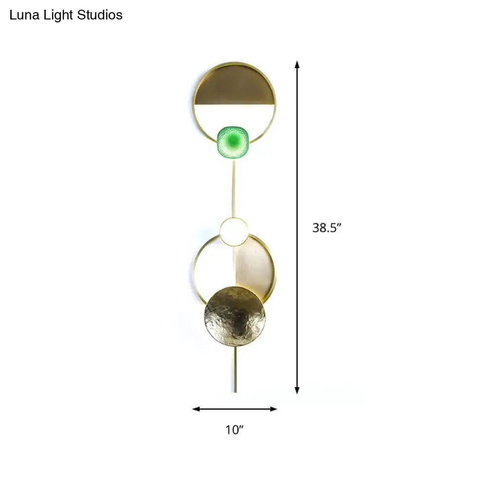 Modern gold and green orbit wall sconce wall lamp with sleek geometric stacked circular design and embedded green accent