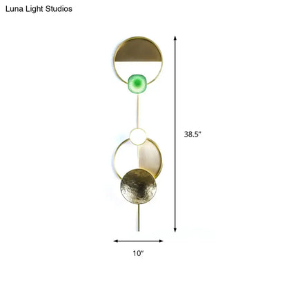 Modern gold and green orbit wall sconce wall lamp with sleek geometric stacked circular design and embedded green accent