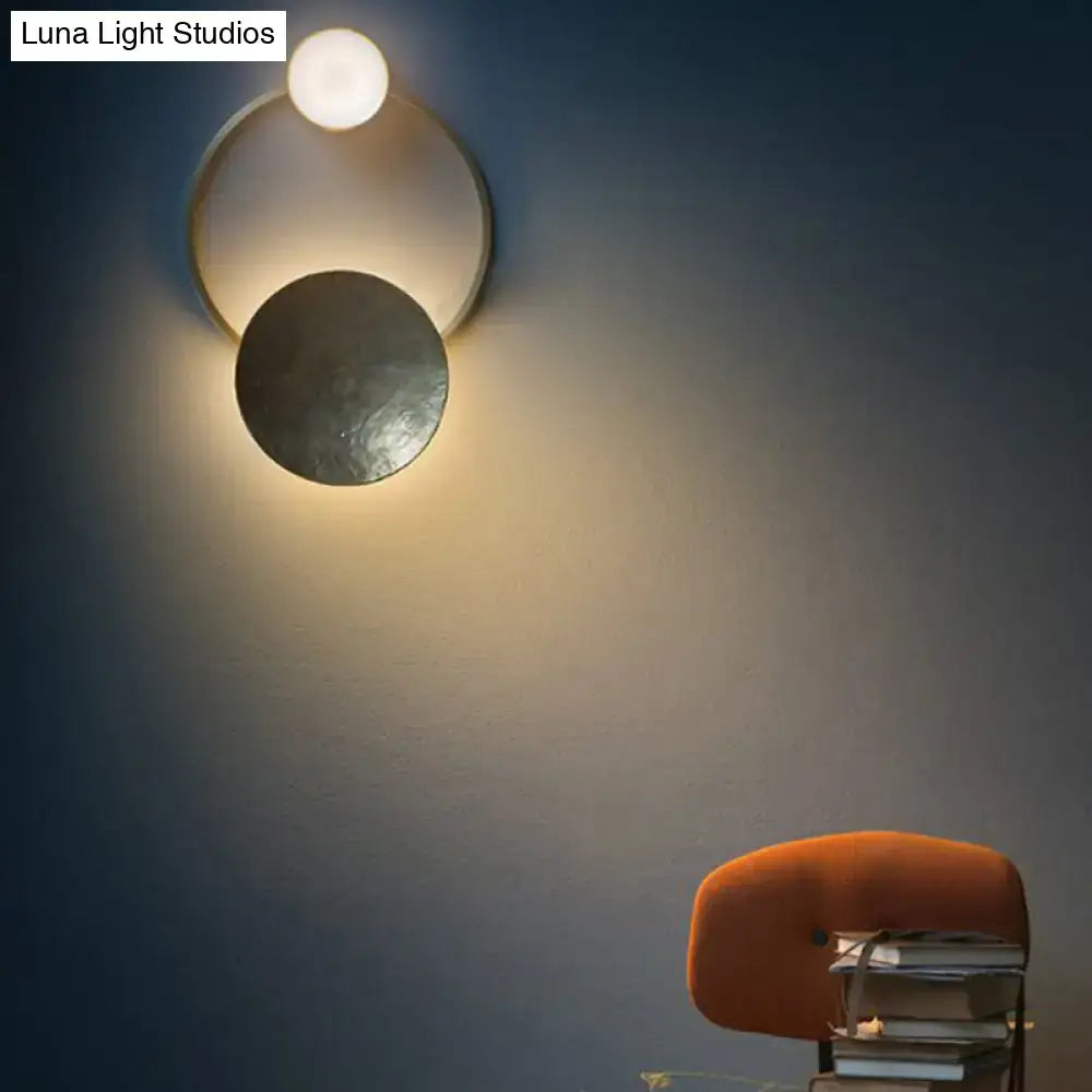 Modern gold and green orbit wall sconce wall lamp with two metallic discs and glowing spherical bulb for bedroom use