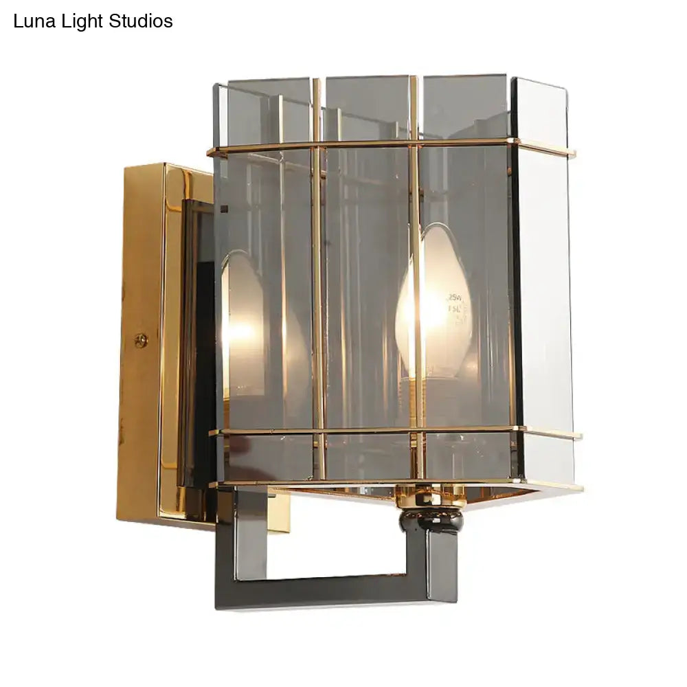 Modern gold and smoke gray glass triangle sconce with geometric smoked glass panels and brass accents for bedroom use