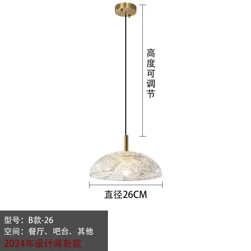 Modern gold pendant light with textured translucent glass dome and brass accents for kitchen and dining room use