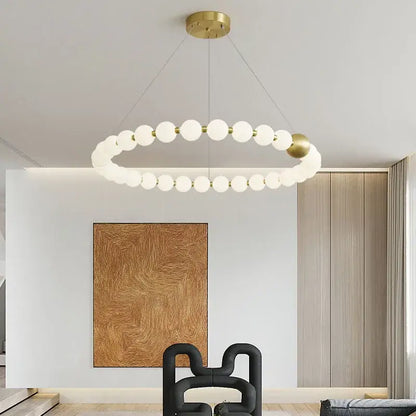 Modern gold and white acrylic led chandelier with gold metal frame and frosted glass spheres by decorbites acrylic led
