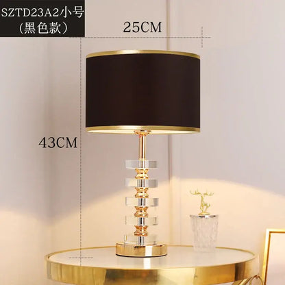 Modern gold and white decorbites crystal table lamp with black lampshade gold trim on clear crystal polished brass base