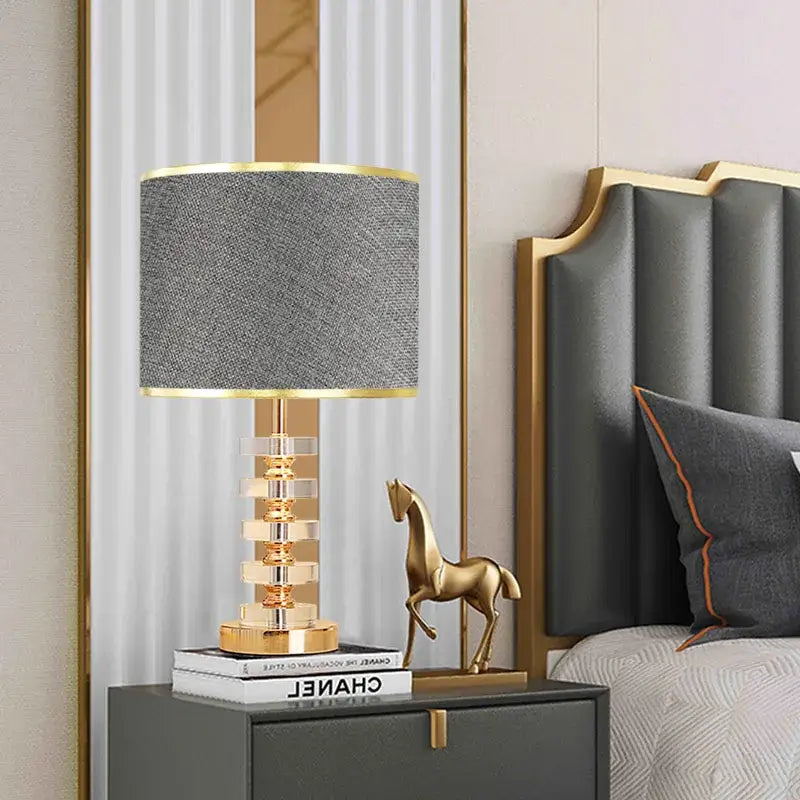 Modern gold and white crystal table lamp with textured gray fabric shade and brass accents for bedroom decorbites crystal table use