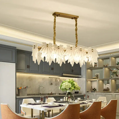 Modern gold pendant light fixture with white glass floral shades and twisted chain frame for dining room use