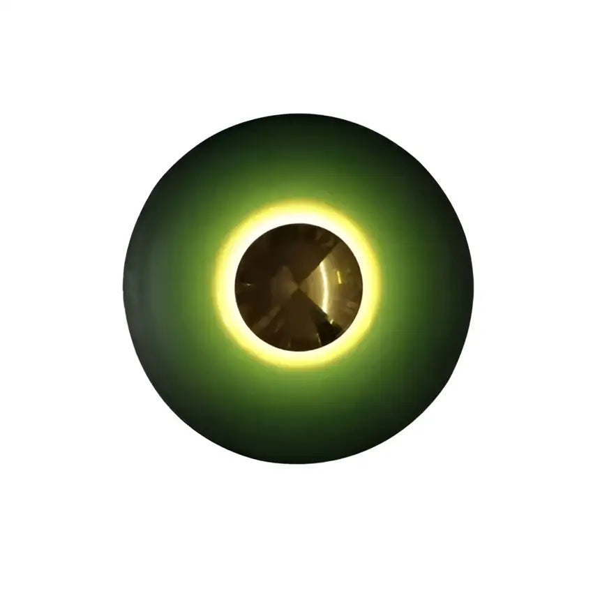 A sleek led ufo wall sconce with deep green ring and glowing yellow halo for bedside bedroom decor