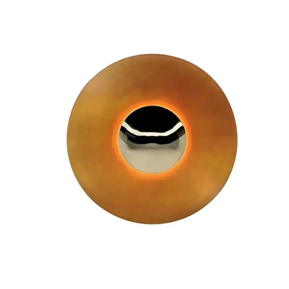Modern gold and white led ufo wall sconce with circular amber plastic button and silver trim for bedside decor