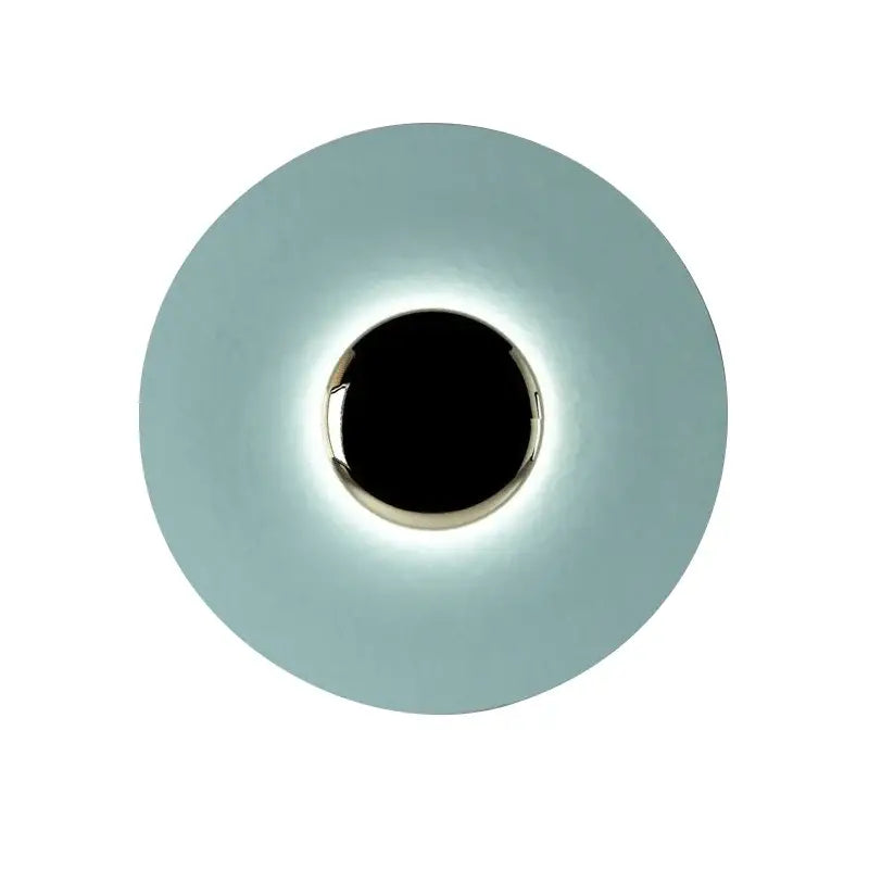 A sleek matte gold and white led ufo wall sconce with a circular design and polished metallic ring for bedroom ambiance