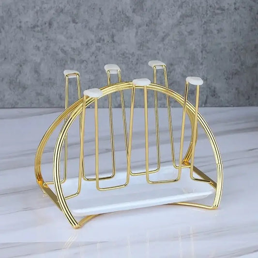 Modern gold and white marble mug holder stand with a rounded curved gold-toned metal cup holder and marble base