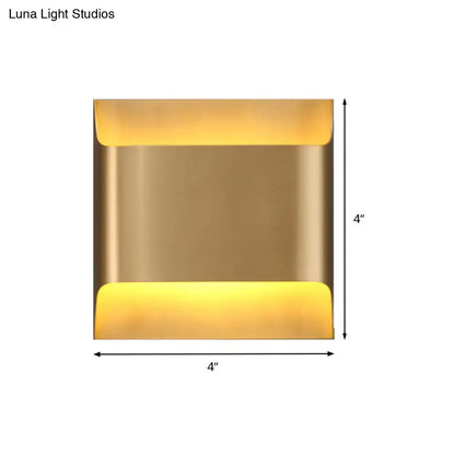 Brass-finished square wall sconce with warm yellow led lighting modern gold angular fixture for living room use
