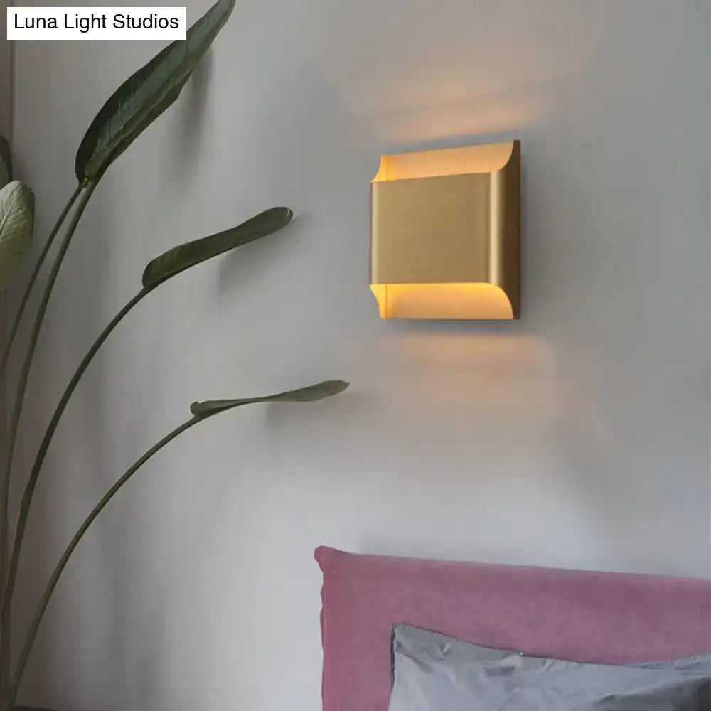 Modern gold angular led light fixture with sleek design and warm ambient lighting for living room walls