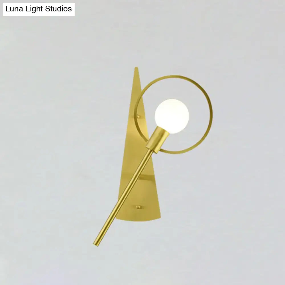 Modern gold angular ring sconce light fixture with sleek backplate and circular ring framing spherical bulb for bedroom