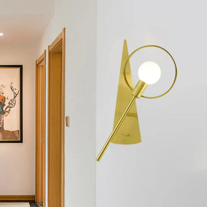 Modern gold angular ring sconce light fixture with sleek circular ring and spherical bulb for bedroom lighting