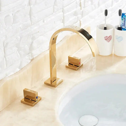 Modern gold arched dual handle basin faucet set with sleek curved spout and square base plates for bathroom use