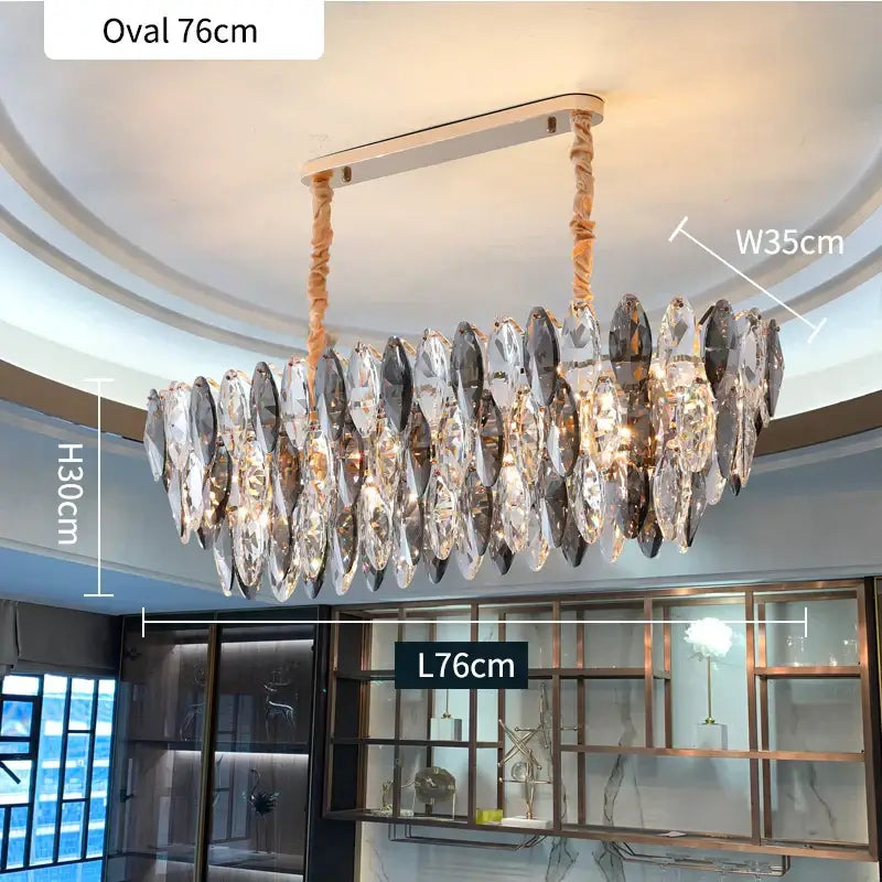 A modern gold ash crystal ceiling chandelier with sleek metallic frame and cascading clear smoky crystal pendants