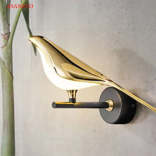 Modern gold bird led wall lamp with sleek reflective finish and black mounting base for bedroom decor wall lamp