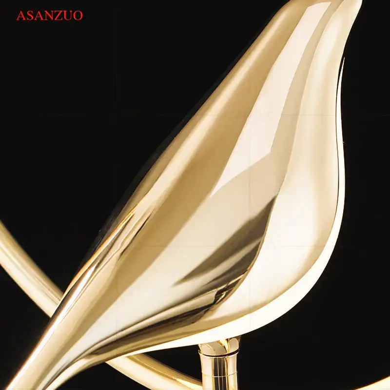 Modern gold bird led wall lamp featuring a sleek curved metallic lampshade for stylish bedroom decor