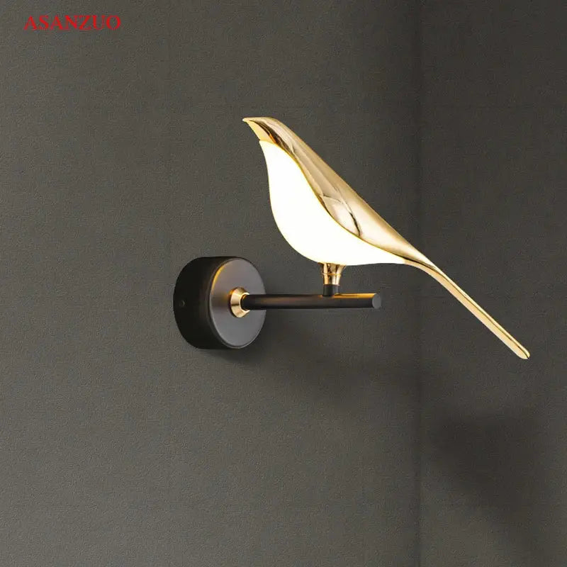 Modern gold bird led wall lamp with sleek design and softly glowing white interior for bedroom decor