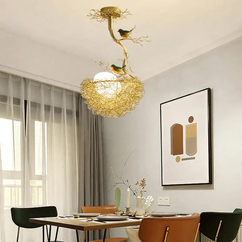 Modern gold bird nest glass pendant lights feature a golden bird-themed ceiling light with intricate branch design