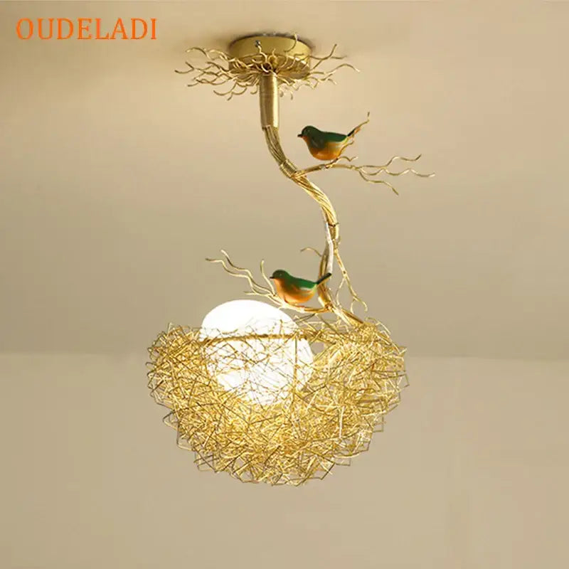 Modern gold-toned metal pendant lights with bird-themed nest glass design featuring green and orange birds for dining room