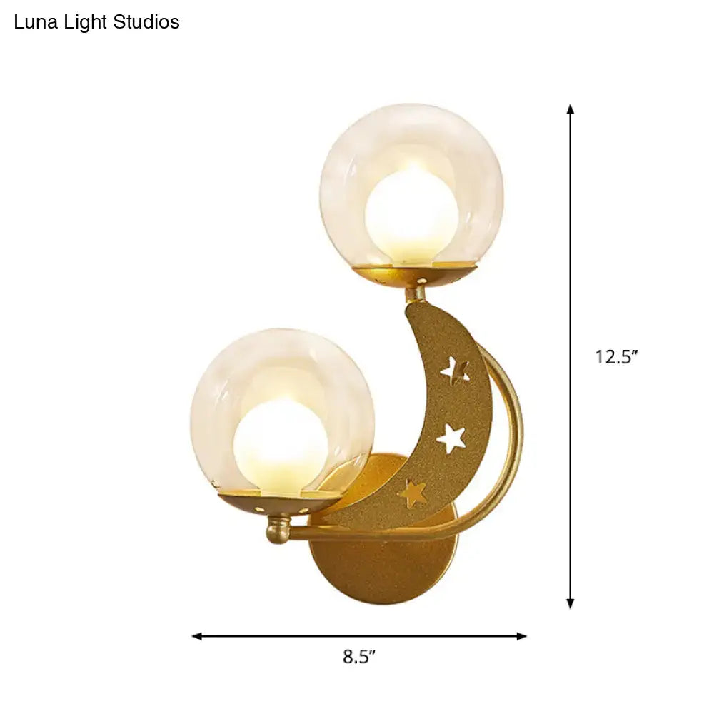 Modern gold and black ball wall sconce with crescent moon design and frosted glass globe shades for bedroom lighting