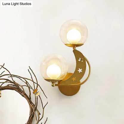 Gold-toned crescent moon wall sconce with cut-out stars and two glass globes modern ball wall sconce for bedroom