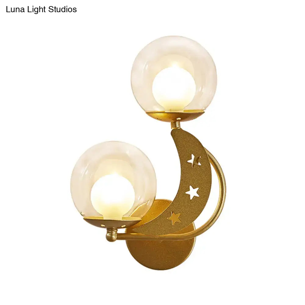 Modern gold and black ball wall sconce with crescent moon design, cut-out stars, and two frosted glass globes