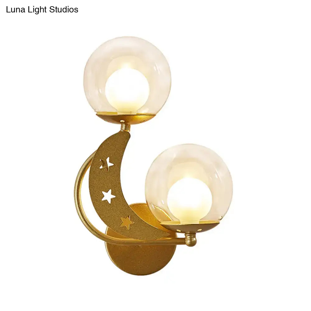 Modern gold and black ball wall sconce featuring crescent moon cut-out stars and two frosted glass globes for bedroom lighting