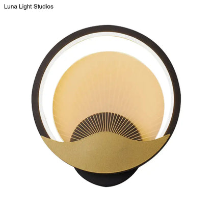 Modern gold and black circular led wall sconce with a black outer ring and illuminated crescent moon accent for bedroom lighting