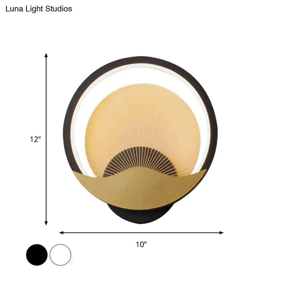 Modern gold and black circular led wall sconce with a black outer ring, gold inner fan design, and illuminated halo