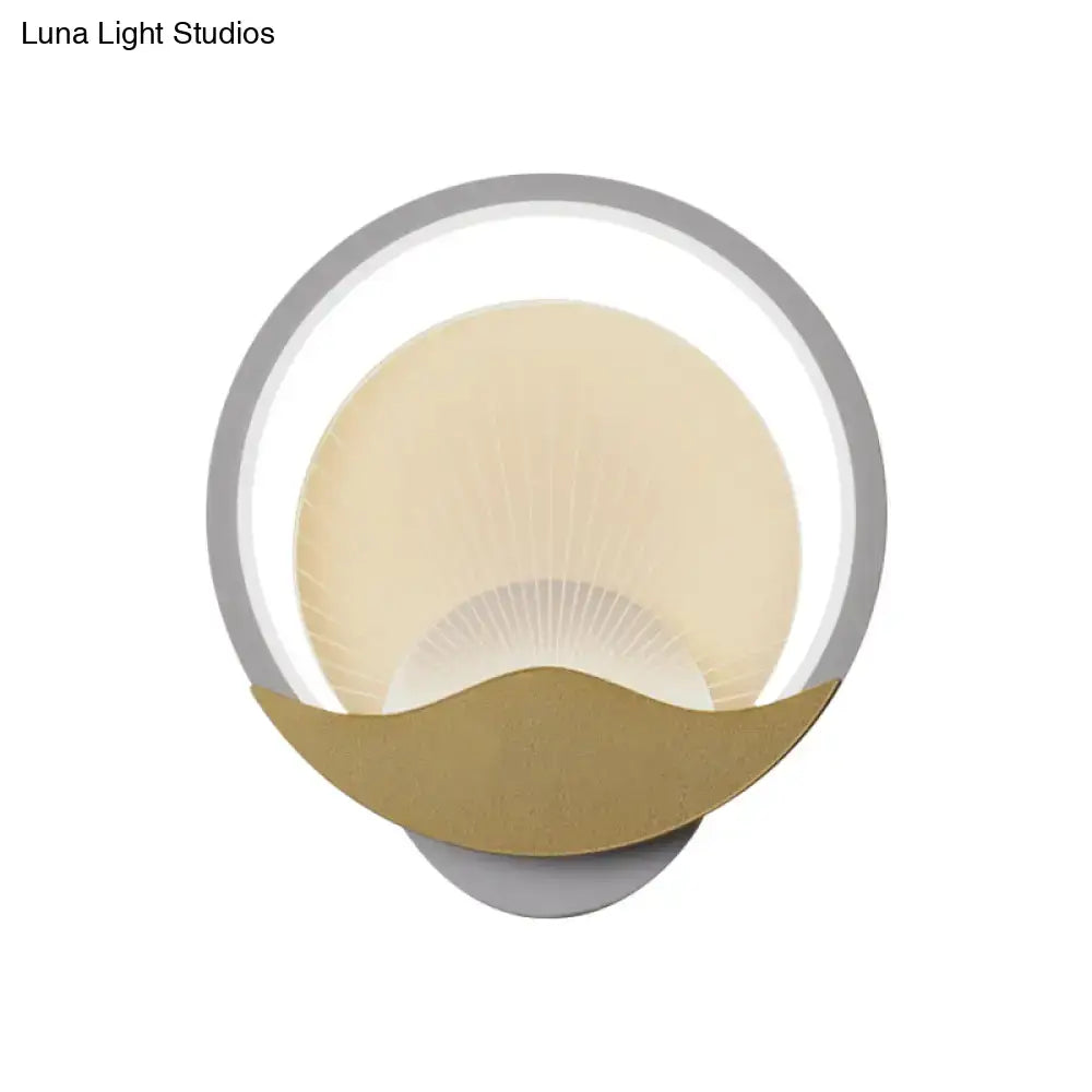 Modern gold and black circular LED wall sconce with sleek silver frame warm cream diffuser and polished gold accent base