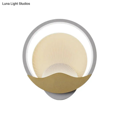 Modern gold and black circular LED wall sconce with sleek silver frame warm cream diffuser and polished gold accent base