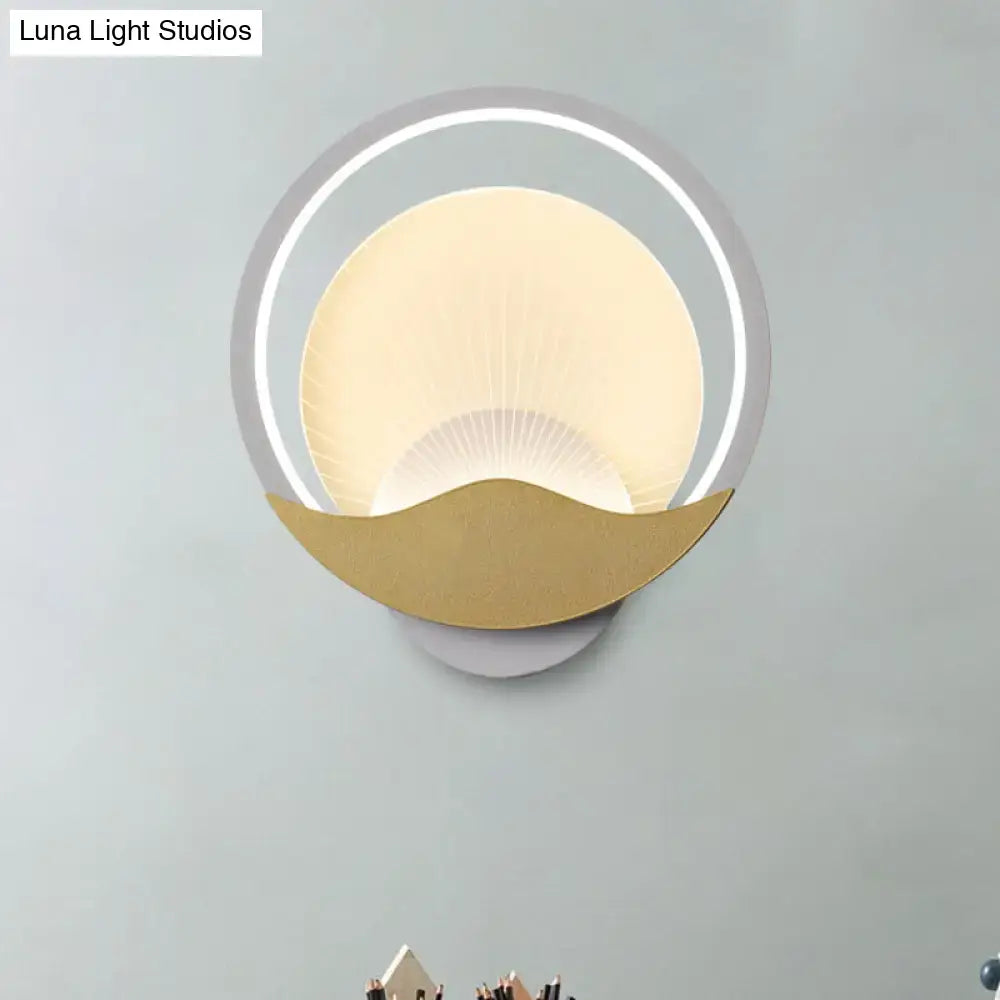 Modern gold and black circular led wall sconce with gold-toned crescent base and frosted glass diffuser for bedroom use