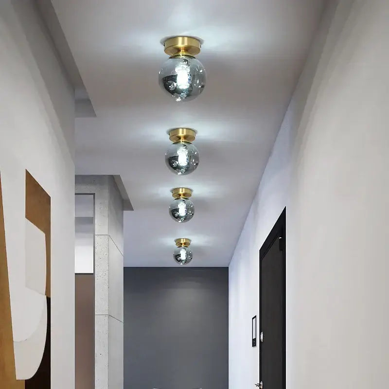 Modern gold black copper led ceiling light with four spherical mirrored glass lights and gold-toned copper led ceiling fixtures
