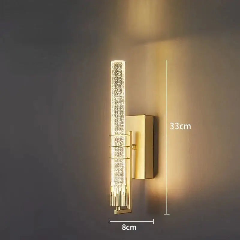 Modern gold and black crystal led wall sconce featuring a gold-toned backplate and vertical crystal encrusted light fixture decorbites crystal led