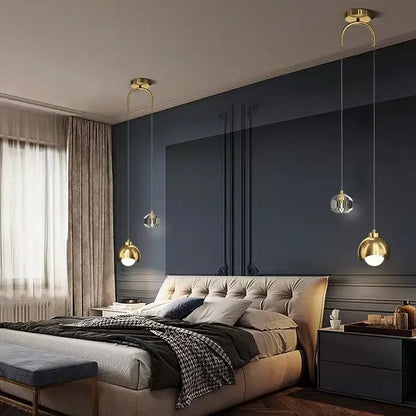 Modern gold and black crystal linear pendant light with three gold-toned spherical glass shades for dining room illumination