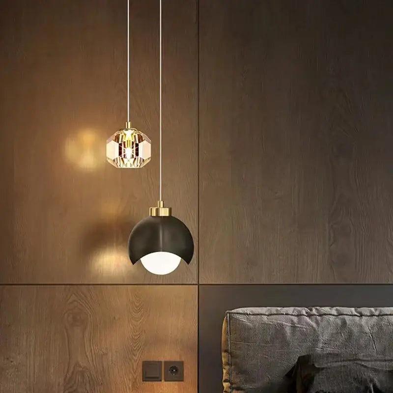 Two modern pendant lights with gold crystal and black dome color options feature bulbs included for dining room use