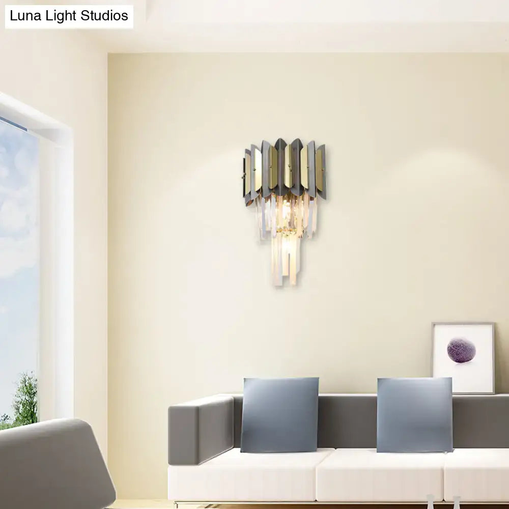Modern gold and black crystal sconce light fixture with geometric metal panels and cascading clear crystal prisms