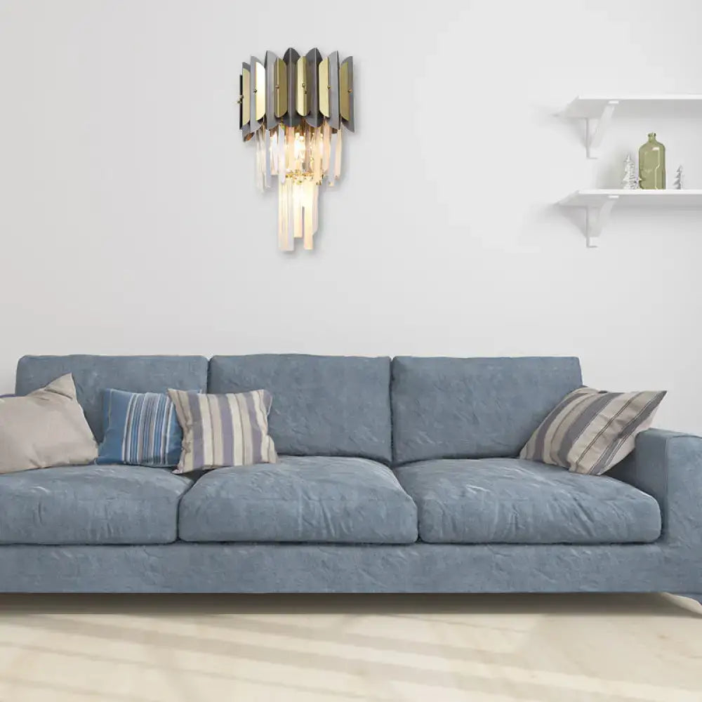 Modern gold and black crystal sconce light fixture with geometric design and cascading clear prisms for bedroom wall use